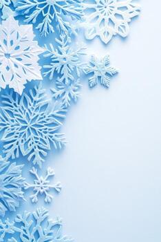 Delicate Snowflakes Create Winter Border on Light Blue Surface photo