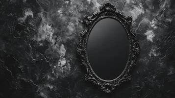 An Antique Ornate Black Mirror on a Dark Textured Wall photo