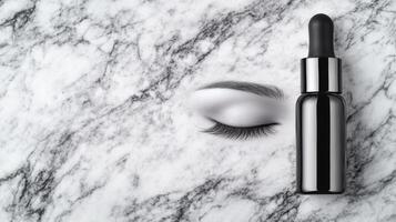 Cosmetic Elixir Beside Realistic Eye on Marble Surface photo