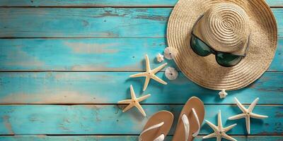 Stylish summer hat and sunglasses on a turquoise wooden surface with starfish and flip flops, evoking a beachy vibe. photo