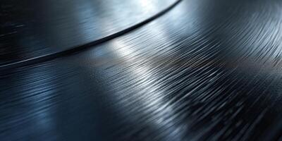 Close-up of a black vinyl record, highlighting its grooves and reflections under soft light. photo
