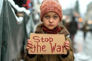 A young Caucasian girl holds a sign reading 'Stop the War,' showcasing her deep blue eyes and determination amidst a snowy backdrop. photo