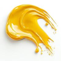 A vibrant yellow paint splash, illustrating creativity and energy against a clean white background. photo