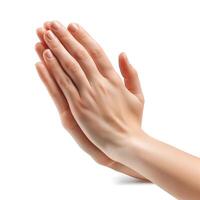 Two delicate hands of a female, elegantly placed in a prayer position against a clean white background. photo
