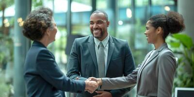 A successful business meeting with a Black male and two women shaking hands, exuding confidence and teamwork in a modern office setting. photo