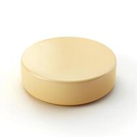 A smooth, round, pale yellow disc resembling a block of butter or cheese, isolated on a soft white background. photo