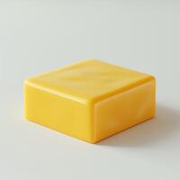 Close-up of a smooth, vibrant yellow block of cheese on a soft, neutral background. photo