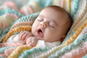 A peaceful Caucasian baby sleeping soundly wrapped in a colorful knitted blanket. photo