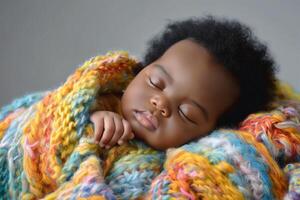 A peaceful sleeping baby wrapped in a colorful, cozy knit blanket, showcasing innocence and tranquility. photo