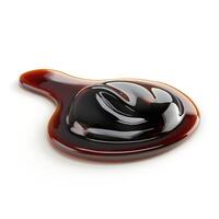 A glossy, dark brown sauce pooling on a white surface, showcasing its rich texture. photo
