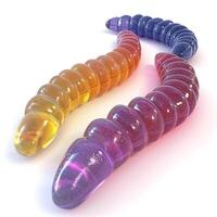 Two colorful, luminous worms intertwining on a white background, creating a captivating abstract design. photo