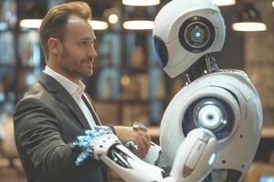 A young Caucasian man in a suit shakes hands with a futuristic robot, showcasing a blend of human and technology interaction. photo