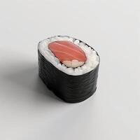 A beautifully arranged piece of sushi featuring fresh salmon atop delicate rice and seaweed. photo