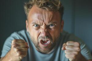 Angry Caucasian man expressing intense frustration with clenched fists and a fierce glare. photo