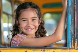 A joyful Hispanic girl with curly hair smiling widely while leaning out of a colorful bus window. photo