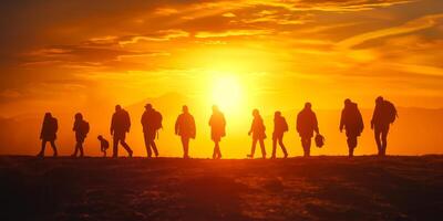 Silhouettes of diverse hikers walking against a vibrant sunset backdrop, creating a sense of adventure and camaraderie. photo