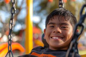 A joyful young Latino boy swinging in a colorful playground, smiling brightly under the sun. photo
