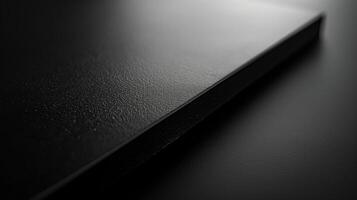 Close-up of a sleek, textured black surface, emphasizing minimalist design and elegance. photo