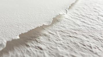 Close-up of textured, torn white paper showcasing intricate fibers and a natural edge. photo
