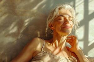 A serene older woman with grey hair enjoys sunlight filtering through patterns, exuding a sense of calm and tranquility. photo