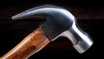 Close-up View of a Steel Hammer With Wooden Handle Resting Against a Dark Background Highlighting Its Design and Craftsmanship photo