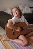 Girl with guitar having fun at home photo