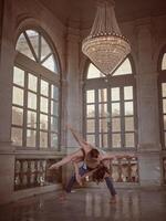Bended dancer with ballerina on back in palace photo