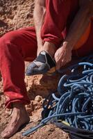 Unrecognizable putting on climbing shoes photo