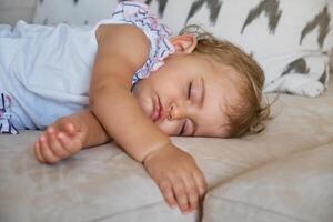 Adorable toddler napping on sofa photo