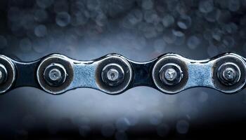 Close-up of a Bicycle Chain Glistening With Moisture in a Well-Lit Workshop During Evening Hours photo