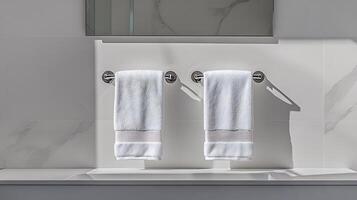 Two white towels hanging on a wall in a bathroom photo