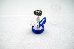 container for cleaning and storing contact lenses for eyes, used at home. For soft and hard lenses, the container consists of two parts, the first part for lenses, open, the second part for liquid photo