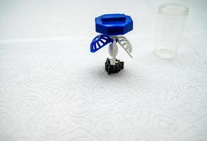container for cleaning and storing contact lenses for eyes, used at home. For soft and hard lenses. the container consists of two parts, the first one for lenses, open, the second part for liquid. photo