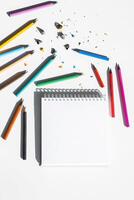 Open Blank Sketchbook And Colorful Crayons On The Desk. photo