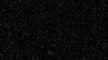 A black background with snow falling from the sky video