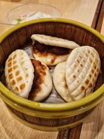 A bowl of steamed buns with meat and vegetables photo