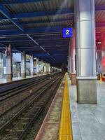 A train station with a train on the tracks photo