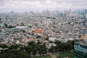 Dense urban sprawl in a vibrant city with modern skyline backdrop photo