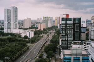 Jakarta cityscape featuring modern buildings, road, and greenery view photo