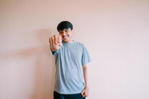 Smiling Young Man Punching Forward with Determination and Confidence photo