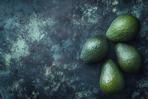 Fresh Avocados on Dark Textured Surface Perfect for Food Photography photo