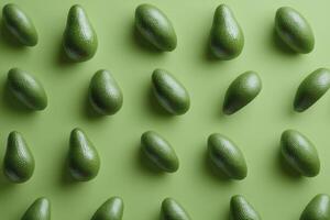 Arrangement of Green Avocados Creating a Healthy Food Pattern on Green photo