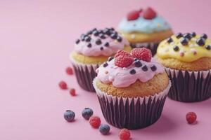 Colorful Cupcakes with Berries and Frosting on Pink Background Display photo