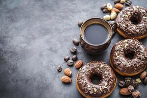 Enjoying Morning Coffee with Chocolate Donuts and Almonds on Dark Background photo