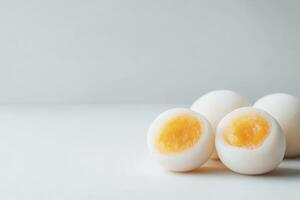 Hard Boiled Eggs Cut in Half Displayed on a White Surface photo