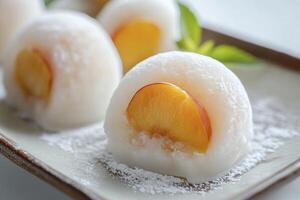 Close Up of Peach Mochi on Plate with Powdered Sugar photo