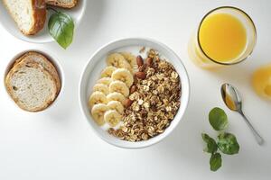 Overhead View of Breakfast Bowl with Granola, Yogurt, Banana and Juice photo