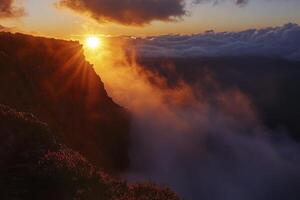Sun Shining Over Mountain Peak with Clouds at Sunset Landscape View photo