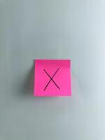 Post it note with cross meaning lie and wrong decision photo