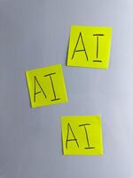 Vertical photo of three sticky notes with the inscription artificial intelligence